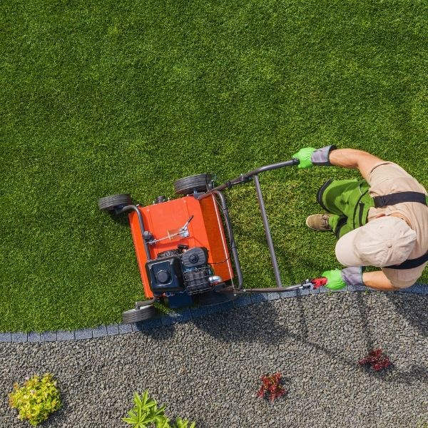 Professional lawn mowing service maintaining a neat green lawn using commercial equipment